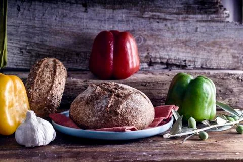 Mediterranean diet. Bread with vegetables composition in a wooden table Stock Photos