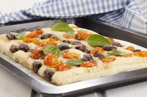 Mediterranean flatbread with cherry tomatoes and olives Stock Photos