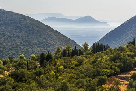 Mediterranean landscape with a view of the sea between two hills. Two more .. Stock Photos
