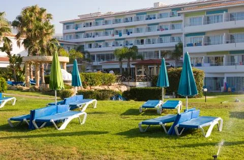 Mediterranean palm beach with empty sunbeds in morning, Paphos, Cyprus Stock Photos
