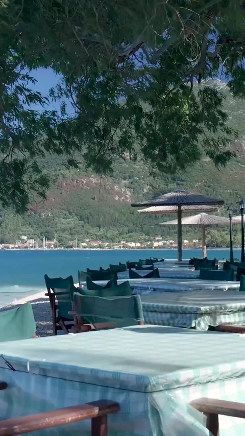 Mediterranean restaurant showing empty tables and chairs waiting for customers Видео 294963980