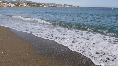 Mediterranean sea beach waves reaching shore white foam in Malaga Spain Stock Footage 100632791