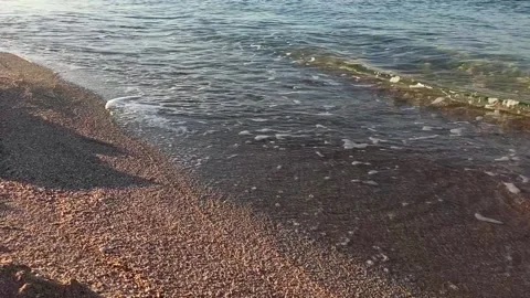 Mediterranean sea waves lapping sand coast in morning light Stock Footage 141128694
