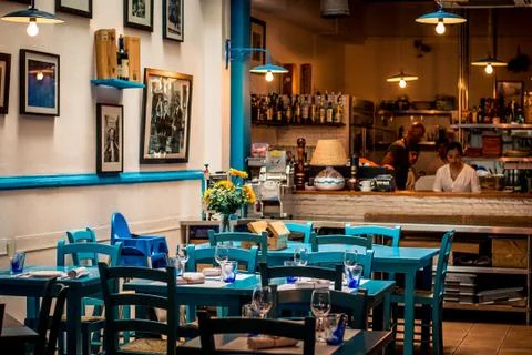 Mediterranean style restaurant with table setting and tableware Stock Photos