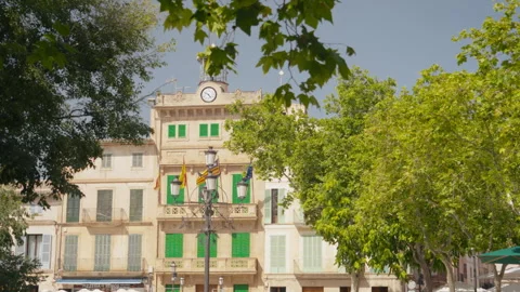 Mediterranean town square with historic clock tower building and street Stock Footage 339417787