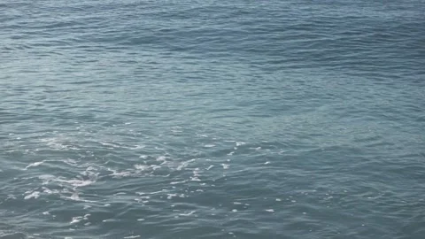 Mediterranean turquoise sea rolling waves hitting beach at bottom left Stock Footage 332774742
