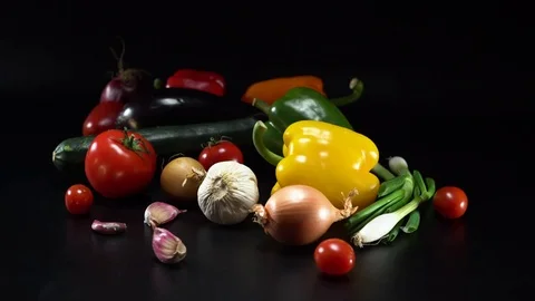 Mediterranean vegetables on black background, panning movement Video stock 75885849