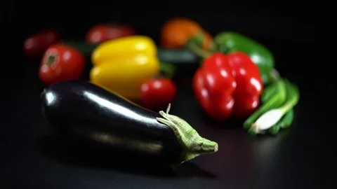 Mediterranean vegetables on black, shallow focus on egg plant 스톡 동영상 75879510