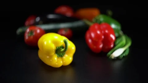 Mediterranean vegetables on black, shallow focus on yellow capsicum Video stock 75882644