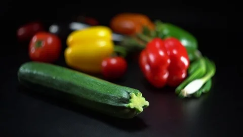 Mediterranean vegetables on black, shallow focus on zucchini 스톡 동영상 75882783