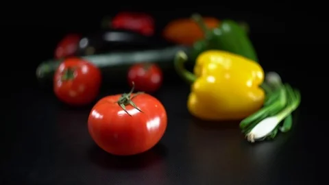 Mediterranean vegetables on black, shallow focus on tomato Video stock 75883900