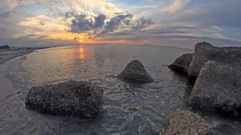 Mediterranean winter sunset between clouds and rocks Stock Photos