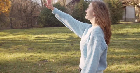 Medium 4k shot of young pretty curly brunet female in autumn park Stock Footage 144979748