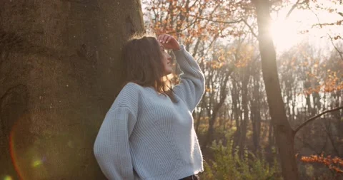 Medium 4k shot of young pretty curly brunet female in autumn park Stock Footage 144979754