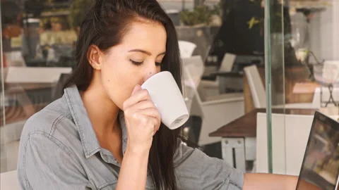 Medium 4k video of a young, beautiful, Latin Hispanic woman taking a coffee brea Stock Footage 201093860