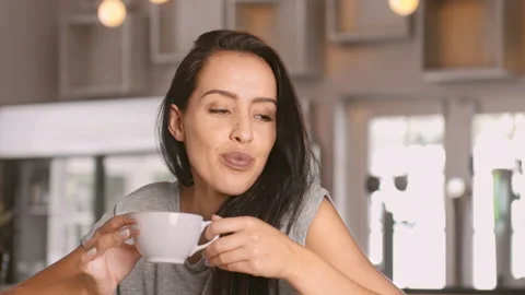 Medium 4k video of a young, beautiful, Latin Hispanic woman drinking coffee in c Vídeo Stock 201093863