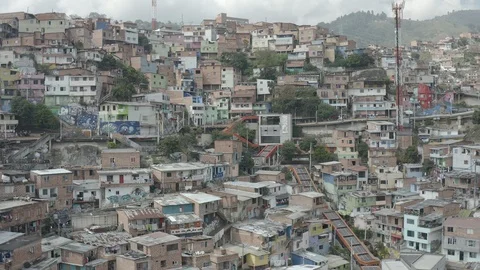 Medium aerial circles around the escalators of Comuna 13 landmark in Medellin Stock-Footage 105621822