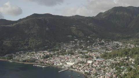 Medium aerial circles around the town of Soufriere in Saint Lucia on sunny day Stock Footage 209619306