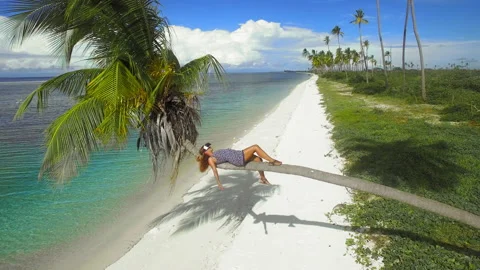 Medium aerial drone quad copter footage of beach woman wearing virtual reality h Stock Footage 199622094
