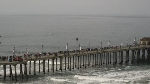 Medium aerial tracking shot of crowd of people on pier 4k slow motion Stock Footage 122009852