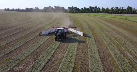Medium Aerial of Tractor and Rake Front - Push Out Stock Footage 221861662