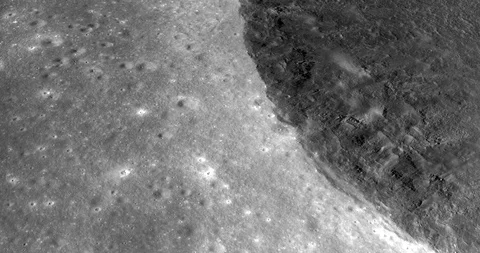 Medium-altitude circular tracking shot: edge of crater near Montes Riphaeus Stock Footage 105602987