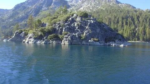 Medium angle of a slow cruise by Fennette Island in Emerald Bay Lake Tahoe Stock Footage 219328530