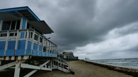 Medium angle view time-lapse of lifeguard house under fast stormy clouds Stock Footage 54242111