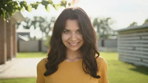 Medium close up of attractive young brunette with beautiful broad smile Stock Footage 244380375
