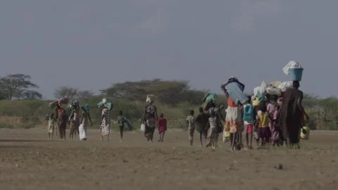 Medium Close-Up Back Shot of People Walking In the Desert Video stock 244750757