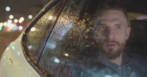Medium close-up of bearded male uber passenger seen through the car window Stock Footage 203829278