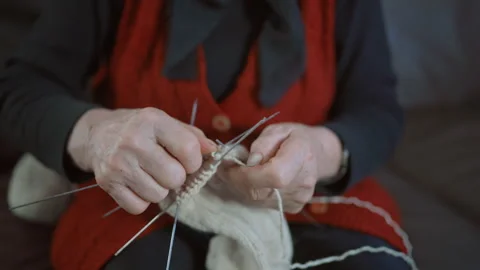 Medium Close Up of Elderly Woman Knitting Wool Socks at Home 스톡 동영상 334085286