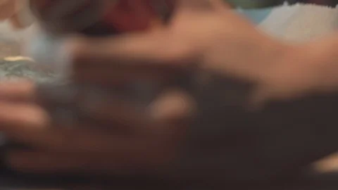 Medium close up finish spreading a tomato paste sauce onto a pizza bread dough Stock Footage 127967999