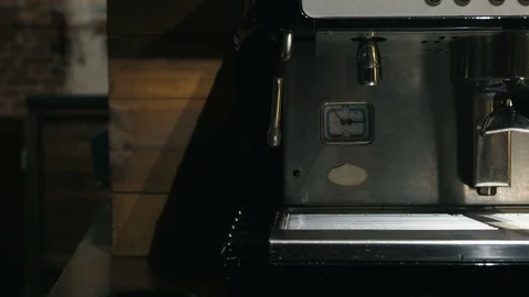 Medium close up of hand washing holder under the water jet of coffee machine Stock Footage 127585897
