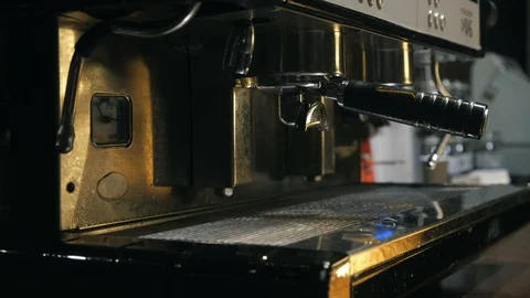 Medium close up of hand washing holder under the water jet of coffee machine Stock Footage 127586129