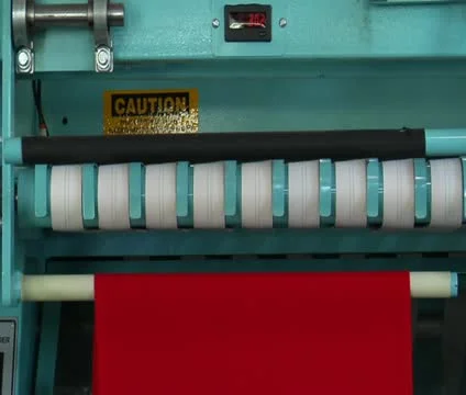 Medium close-up of industrial ironing machine and red cloth Stock Footage 21593571