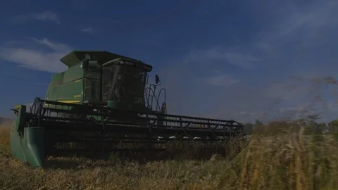 Medium close up of John Deere tractor preparing to harvest new path on Stock Footage 109595938