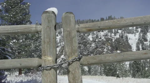 Medium close up of a locked gate on a snowy mountain road Stock Footage 47382308