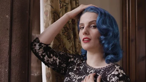 Medium close up of model by window Stock Footage 109488447