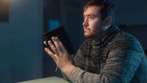 Medium Close Up One Man Holding Holy Bible Looking Upward At Night 스톡 동영상 333270798