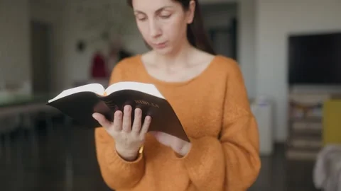 Medium Close Up One Woman Reading Open Holy Bible In Modern Home Stock Footage 334040588