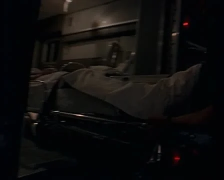 Medium close up as the paramedic load the gurney and the patient into the back Video stock 11688453