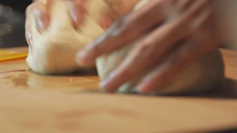 Medium close up pizza dough bread separate into two equal piece before shaping Stock Footage 127963429