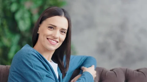 Medium close-up portrait of casual smiling young woman looking at camera in Stock Footage 104217316