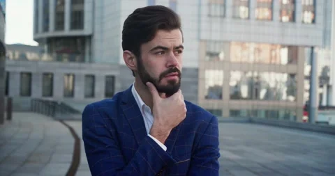 Medium close up. Portrait of Handsome young businessman standing outside the Stock Footage 166684366