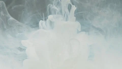 Medium close up shot of abstract white paint slowly dissolves in water Stock Footage 147313780