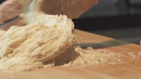 Medium close up shot hand kneading a wet and high hydration pizza dough Stock Footage 127958161