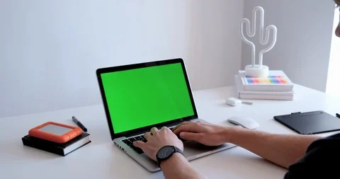 Medium close up shot of a man typing on a laptop keyboard in a casual office Stock-Footage 127063745