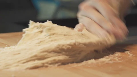 Medium close up shot one hand kneading sticky dough for pizza bread base Stock Footage 127958385