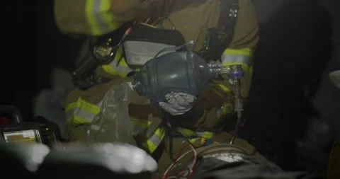 Medium close shot of Paramedic using Bag Valve Mask on pt Stock Footage 255020961